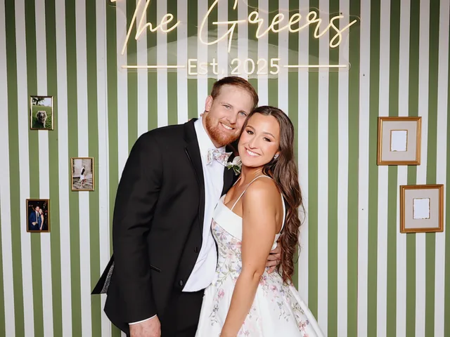 Couple photographed against a green and white striped wall.